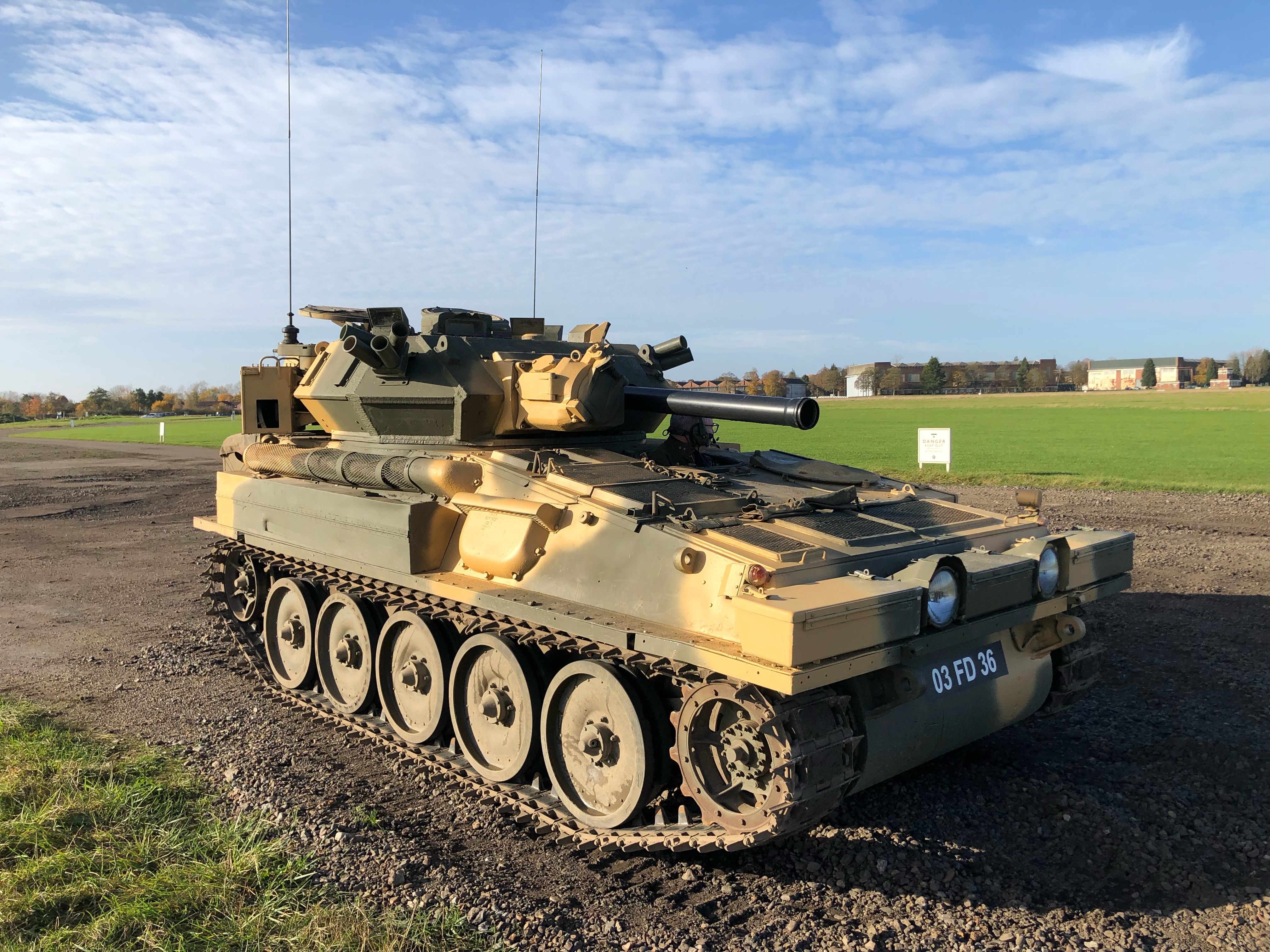 Visitors riding in a military tank